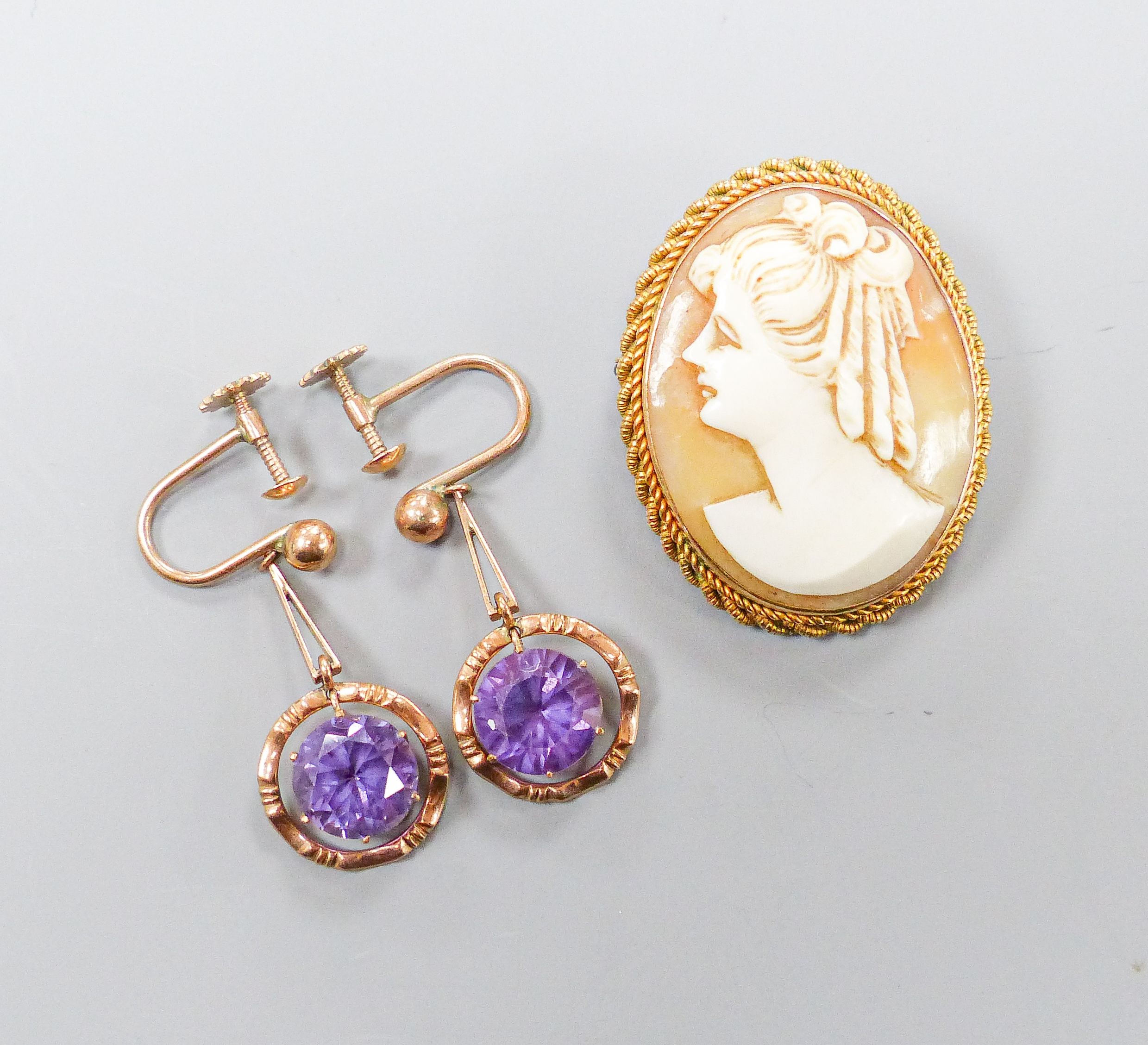 An oval cameo brooch in 9ct mount with rope-twist edge, 35mm and a pair of 9ct drop earrings set with circular synthetic sapphires, gross weight 12.8 grams.